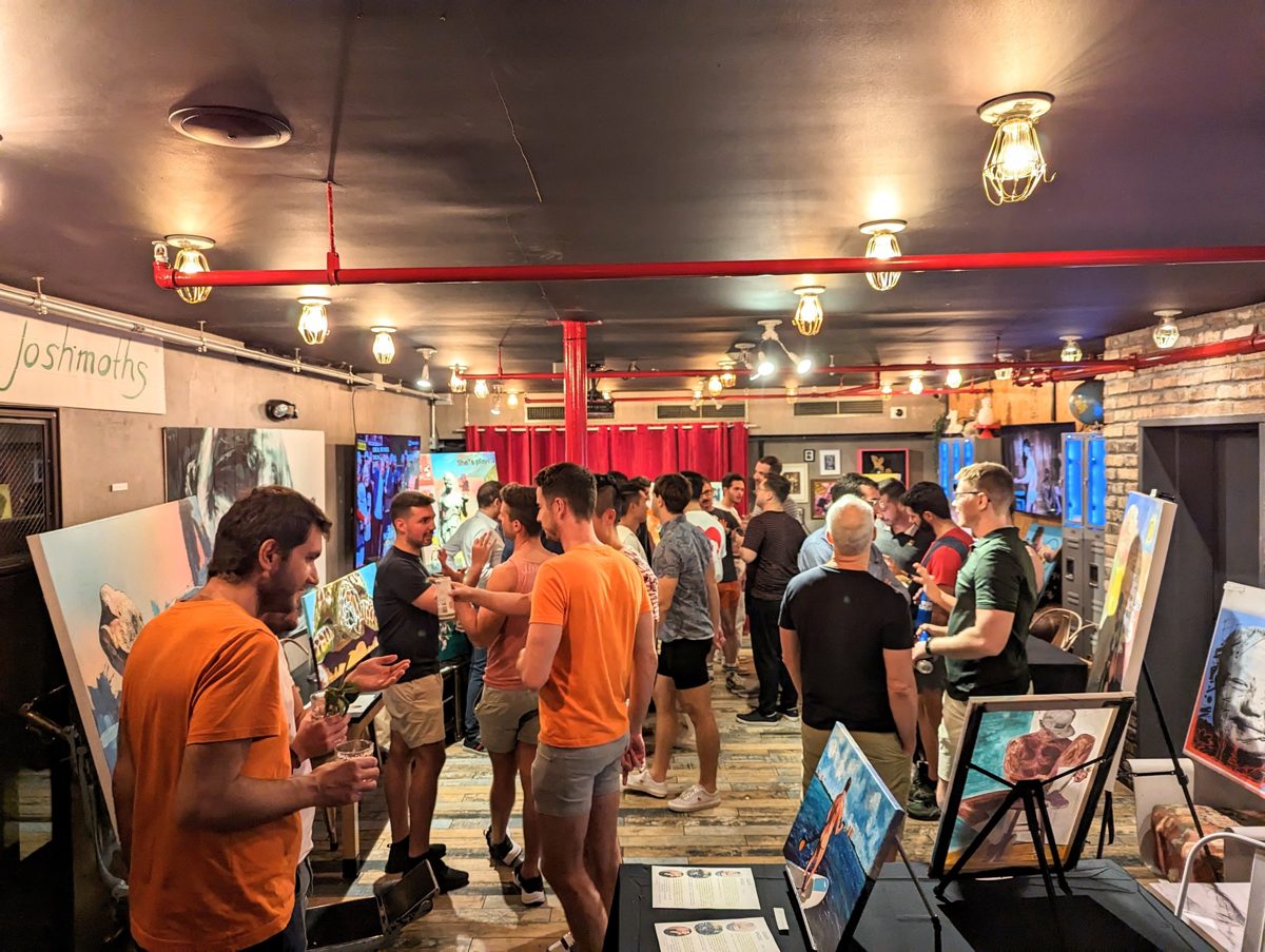 The room during a Queer Easels showcase, art on display